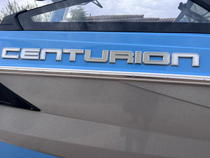 Close-up of a vehicle with 'Centurion' branding on a blue and gray background.